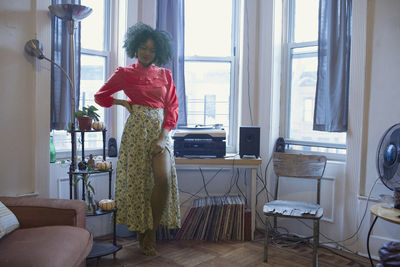 A young woman posing by windows