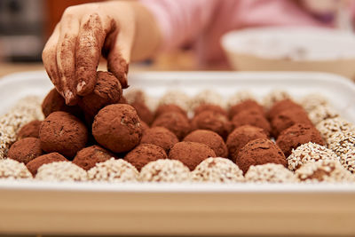 Close-up of hand holding food in tray