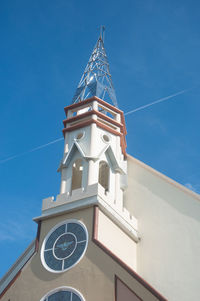 Low angle view of bell tower against blue sky