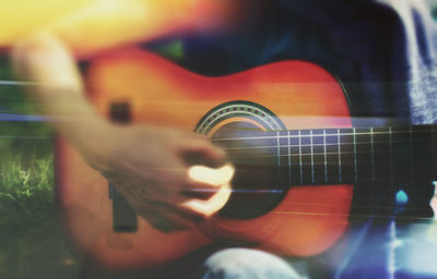 Close-up of man playing guitar