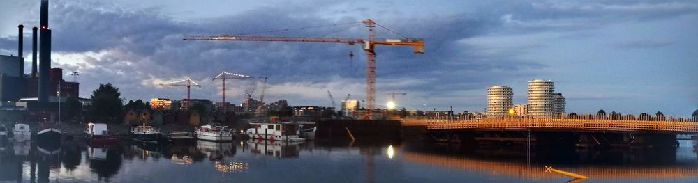 Panoramic view of sailboats in city against sky