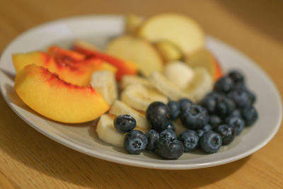 Close-up of fruits in plate on table