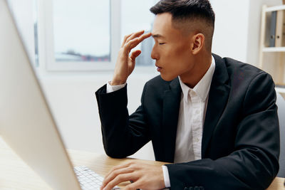 Businesswoman using laptop at office