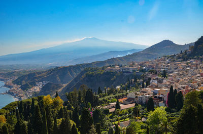 High angle view of townscape and mountains against sky