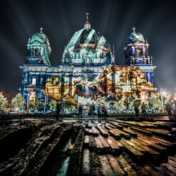 People in front of illuminated berlin cathedral at night