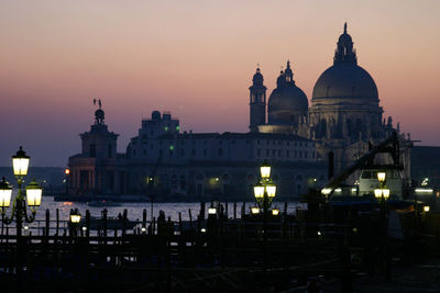 Illuminated cathedral against sky at dusk