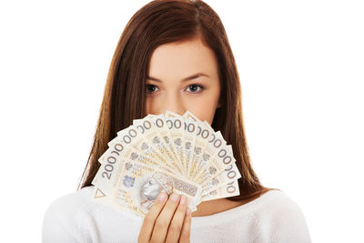 Portrait of a beautiful young woman against white background