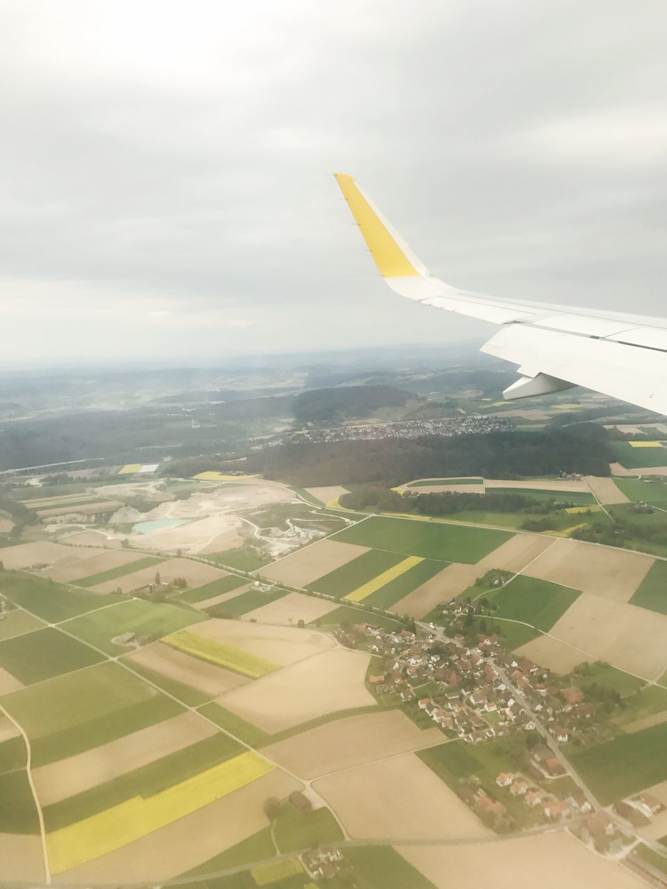 aerial view, landscape, flying, agriculture, scenics, transportation, no people, nature, airplane, tranquility, day, aircraft wing, outdoors, sky, patchwork landscape, beauty in nature