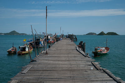 Boats moored at pier