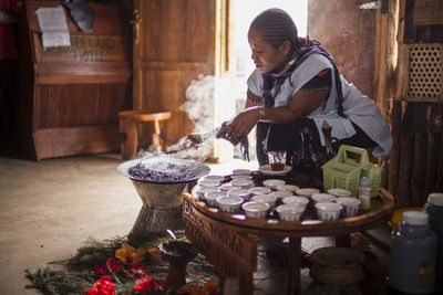 Woman preparing food on table at restaurant