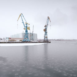 Commercial dock by sea against sky