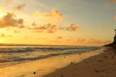 Scenic view of beach against sky during sunset
