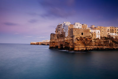 View of town by sea against sky