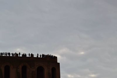 Low angle view of historical building against cloudy sky