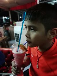 Close-up portrait of boy drinking glass