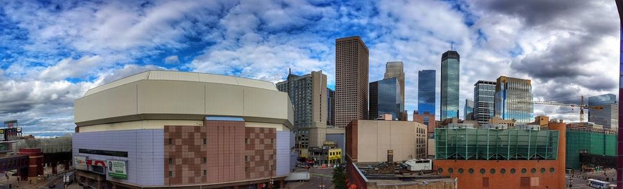 Modern buildings against cloudy sky