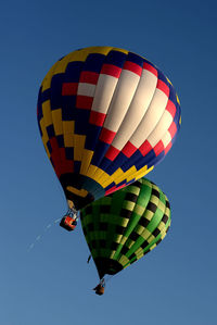 Low angle view of hot air balloons against clear sky