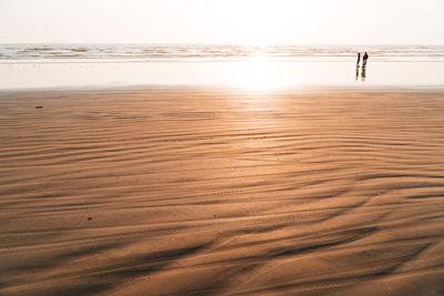 Scenic view of beach against sky during sunset