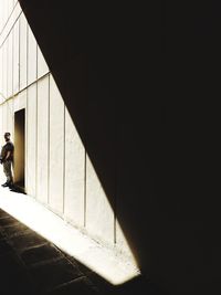 Shadow of woman walking on building wall