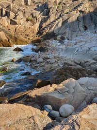 High angle view of rock by sea