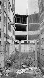 Empty road by buildings in city