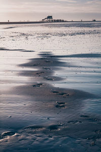 Scenic view of beach against sky during sunset