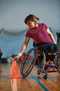 Side view of woman sitting on wheelchair