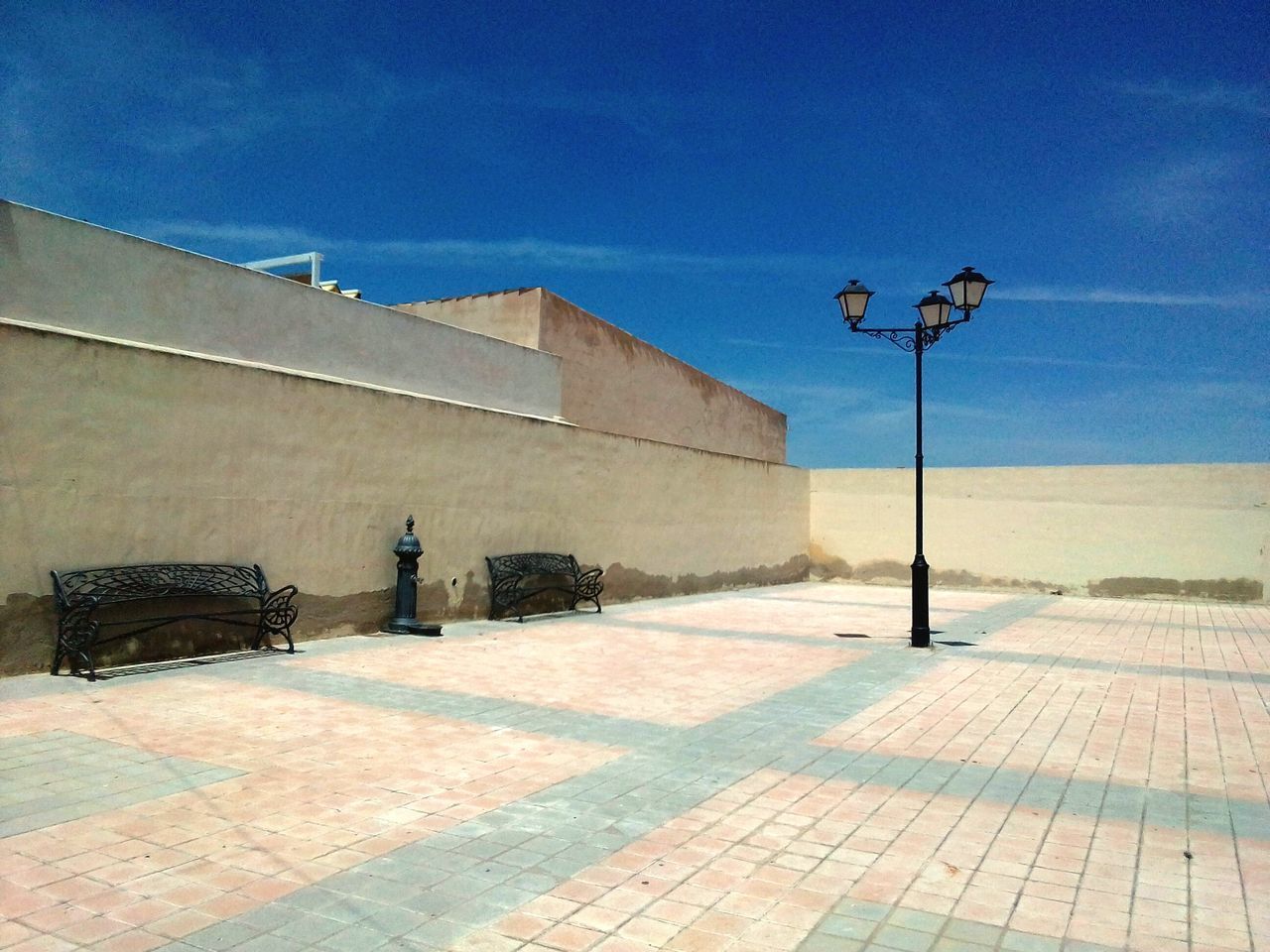 STREET BY WALL AGAINST BUILDINGS