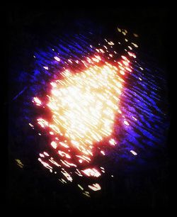 Low angle view of illuminated lights at night