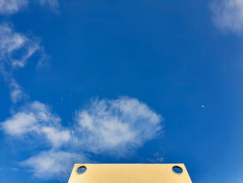 Low angle view of smoke against blue sky