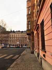 Street amidst buildings in city against sky