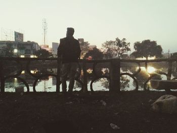 Man and cityscape against clear sky