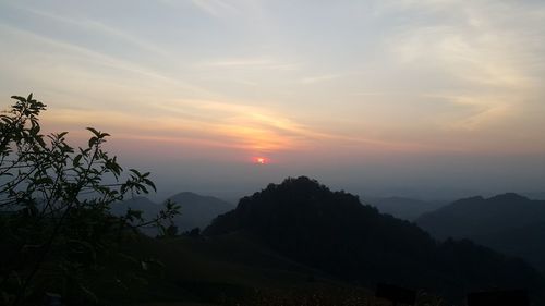 Scenic view of silhouette mountains against sky at sunset