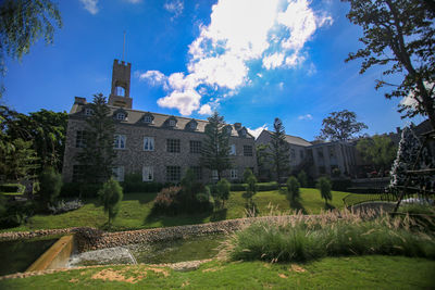 Panoramic view of old building and trees against sky