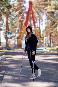 Portrait of young woman standing in city