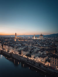 An aerial view of the illuminated city of florence at dusk and during blue hour