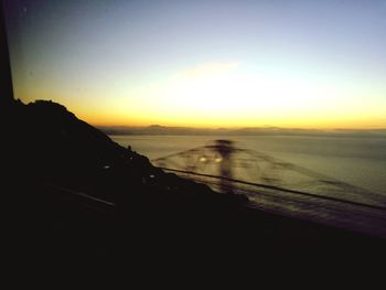 Scenic view of silhouette landscape against clear sky during sunset