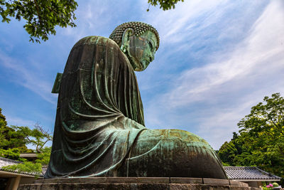 Low angle view of statue against sky