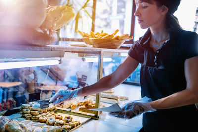 Young woman working at bakery