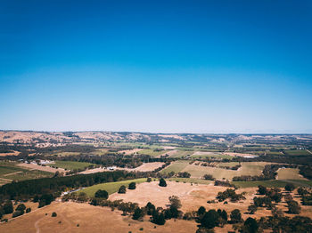 Aerial view of landscape against clear blue sky