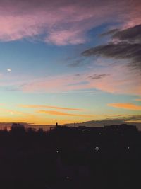 Silhouette buildings against sky during sunset