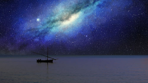 Fishing boat sails under the milky way at night