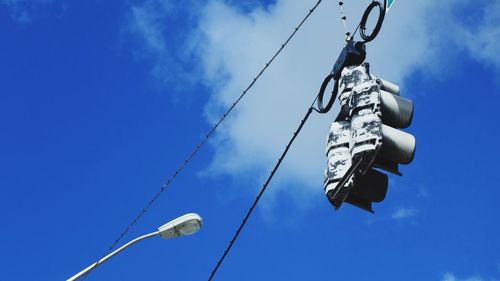 Low angle view of cables against blue sky