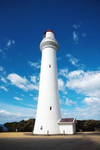 Low angle view of lighthouse against blue sky