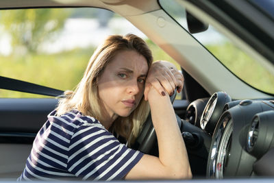 Portrait of woman sitting in car