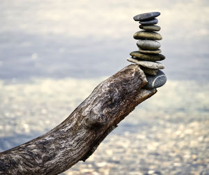 Close-up of stone stack on rock at beach