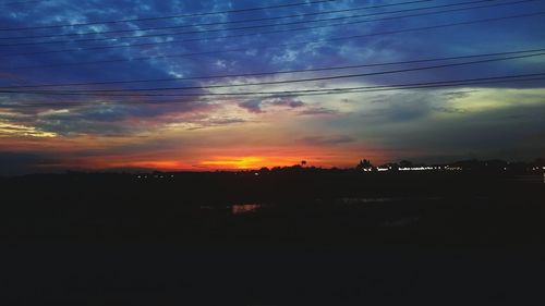 Silhouette landscape against sky during sunset