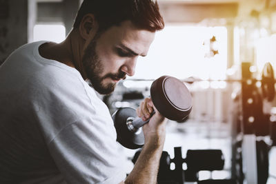 Portrait of young man holding camera