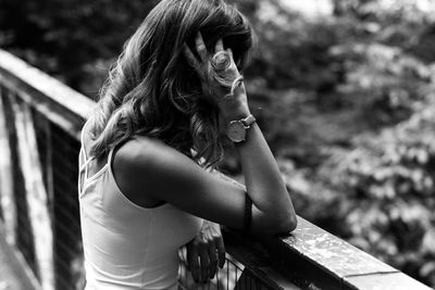 Young woman standing on bridge