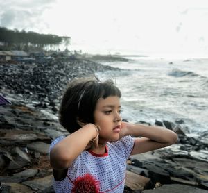 Portrait of woman standing on beach